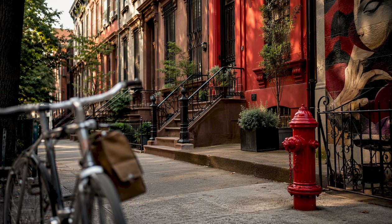 Brooklyn brownstone street with bike and delivery bag