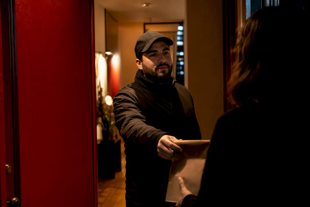 Discreet cannabis delivery handoff at NYC doorway