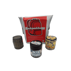 Backpack Boyz x Doja cannabis collaboration featuring a large silver bag with red Backpackboyz branding and three 3.5g flower jars labeled Billy Kimber, Blue Toro, and Lulu on a white background.