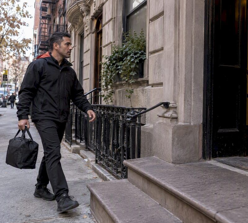 Courier approaching a Manhattan apartment before rush hour