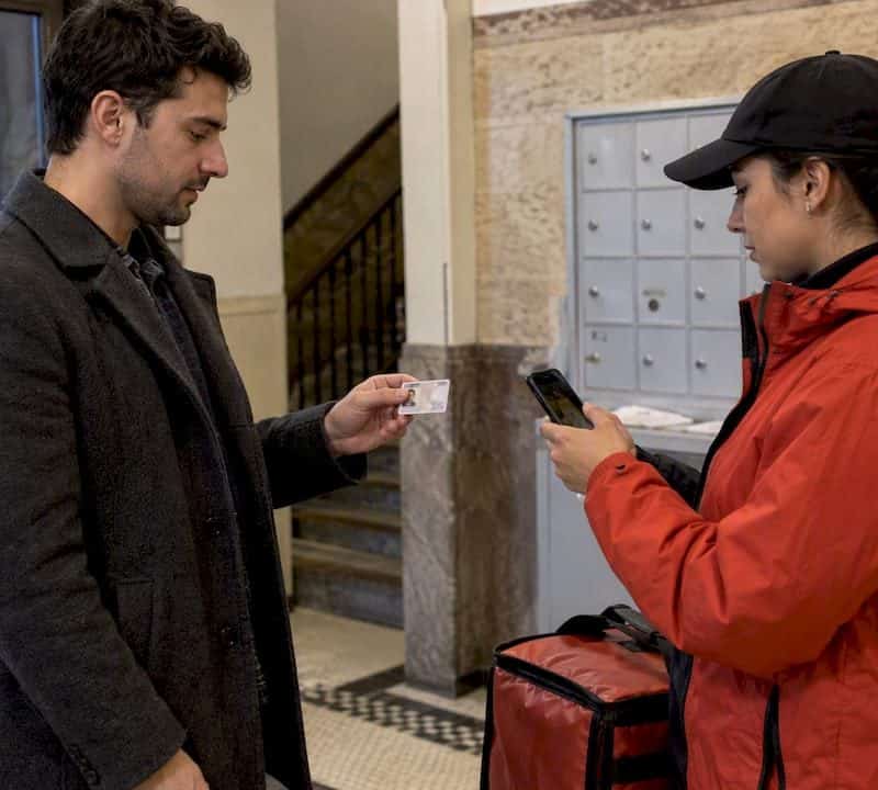 Customer presents ID during a delivery handoff