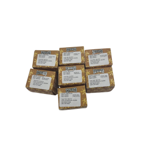 Stack of gold-embossed Smashed Crumble 1-gram concentrate packaging boxes with lab test strain labels