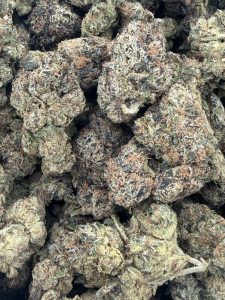 Dense, trichome-frosted Super Obama Runtz hybrid buds showing deep purple and green hues with orange pistils